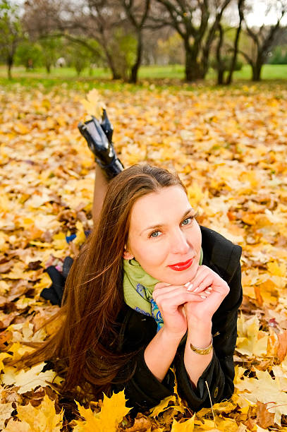 istock woman on maple leaves 102740684