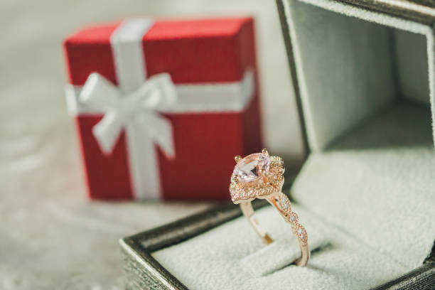 istock jewelry pink diamond ring with red gift box background 1027407004