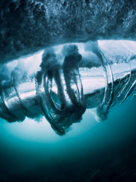 istock Underwater wave texture. Barrel wave crashing in ocean with sunlight. 1027408326
