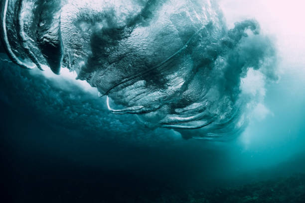 istock Barrel wave crashing in tropical ocean with sunlight. Underwater wave texture 1027409676