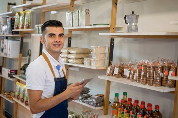 istock Salesman at a healthy store and looking at an order on tablet 1027410112