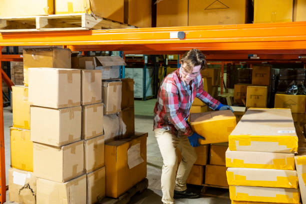 istock A male warehouse worker removing a box from under some racking. 1027418832