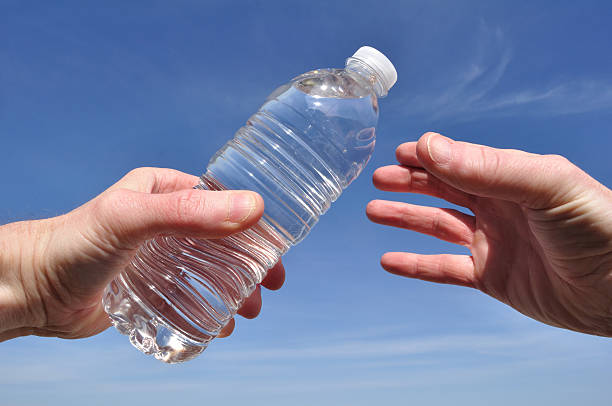 Thirsty person reaching for refreshing bottle of water  stock photo