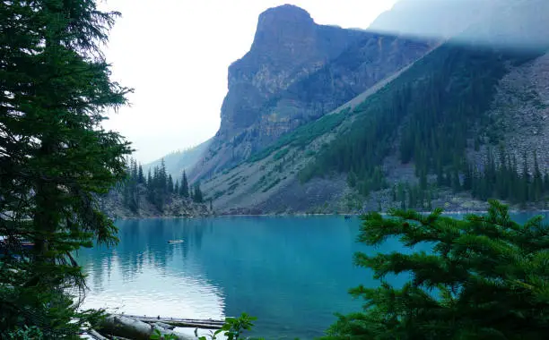 View of Moraine Lake through the fog of the morning, just after sunrise
