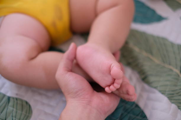 istock My son's feet on my hand 1027438076