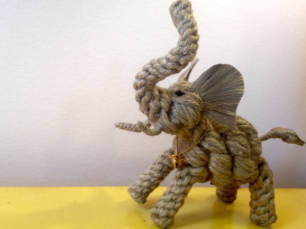 istock Elephant made of twine on yellow tabletop 1027461028