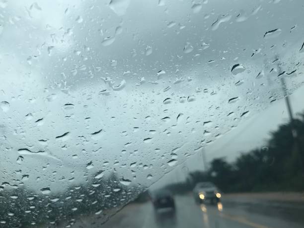 istock countryside road view from car's front windscreen which focus on raindrops 1027461582