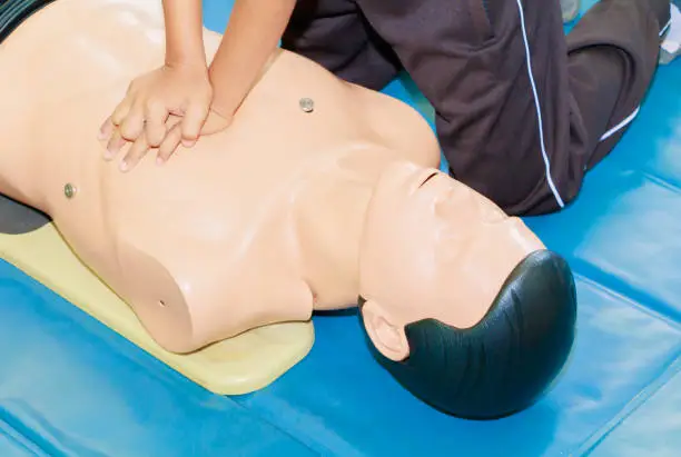 hand student Heart pump with medical dummy on CPR, in emergency refresher training to assist of physician