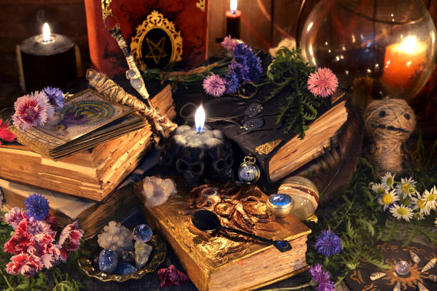 istock Still life with old witch books, antique lamp, black candles, voodoo doll and ritual objects 1027466572