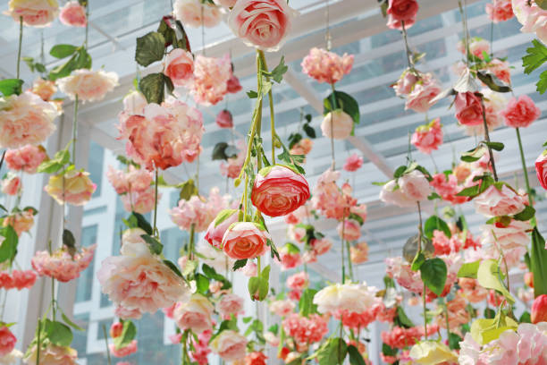 Many different type of sweet artificial flower hanging from ceiling. Beautiful Upside down flowers.