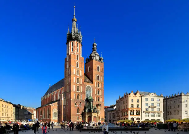Krakow, Lesser Poland / Poland - 2017/03/28: Cracow Old Town, St. Mary cathedral and medieval tenements by Main Market Square