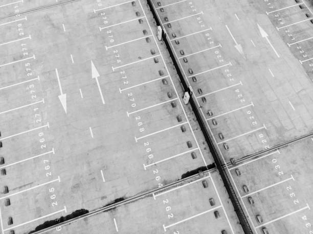istock white marking lines of empty parking lot, view from above 1027483318