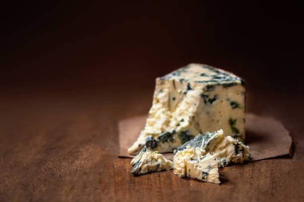 Blue cheese Gorgonzola on a rustic wooden background. Mold cheese with copyspace