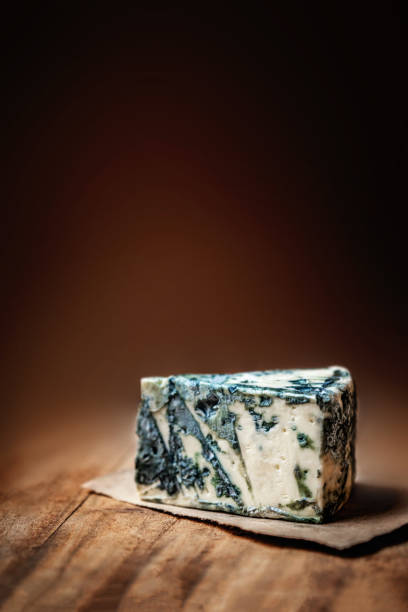 istock Blue cheese Gorgonzola on a rustic wooden background. Mold cheese with copyspace