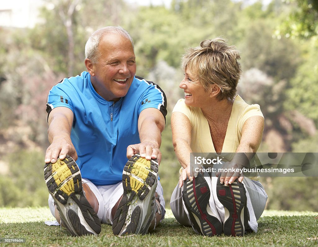 Senior couple exercising together in park  50-59 Years Stock Photo