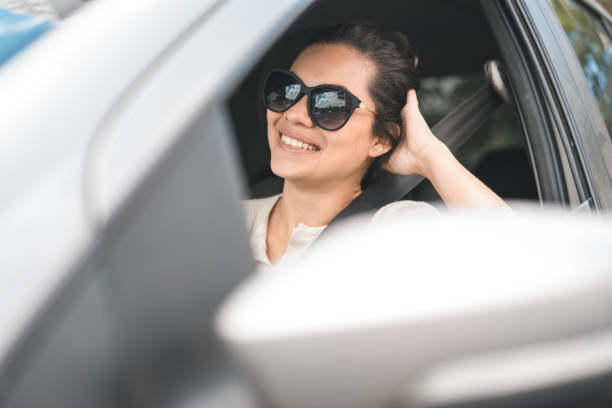 istock Happy woman traveling by car 1027496840