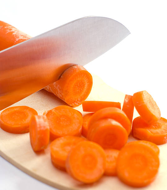 Chopping a carrot stock photo