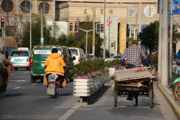 Tricycle driver on a busy street in Hongkou district, Shanghai, China