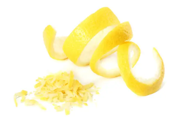 Photo of fresh lemon peel and lemon zest isolated on white background. healthy food