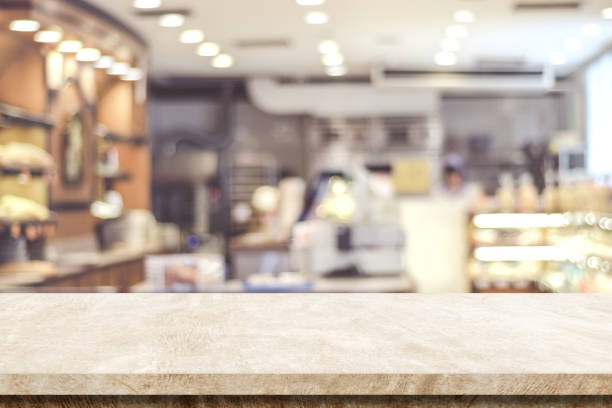 istock Empty brown cement table over blur cafe background, product and food display montage 1027513170