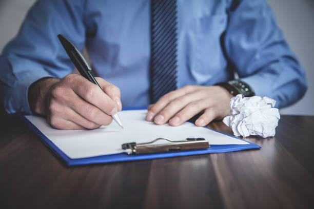 Businessman writing on paper in the office