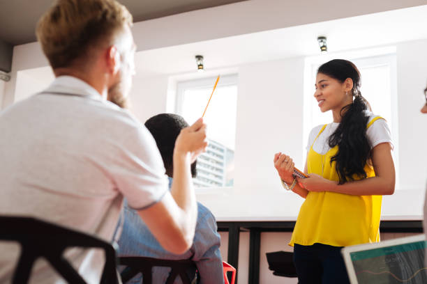 istock Young girl looking at the fellow students at self growth workshop 1027521998