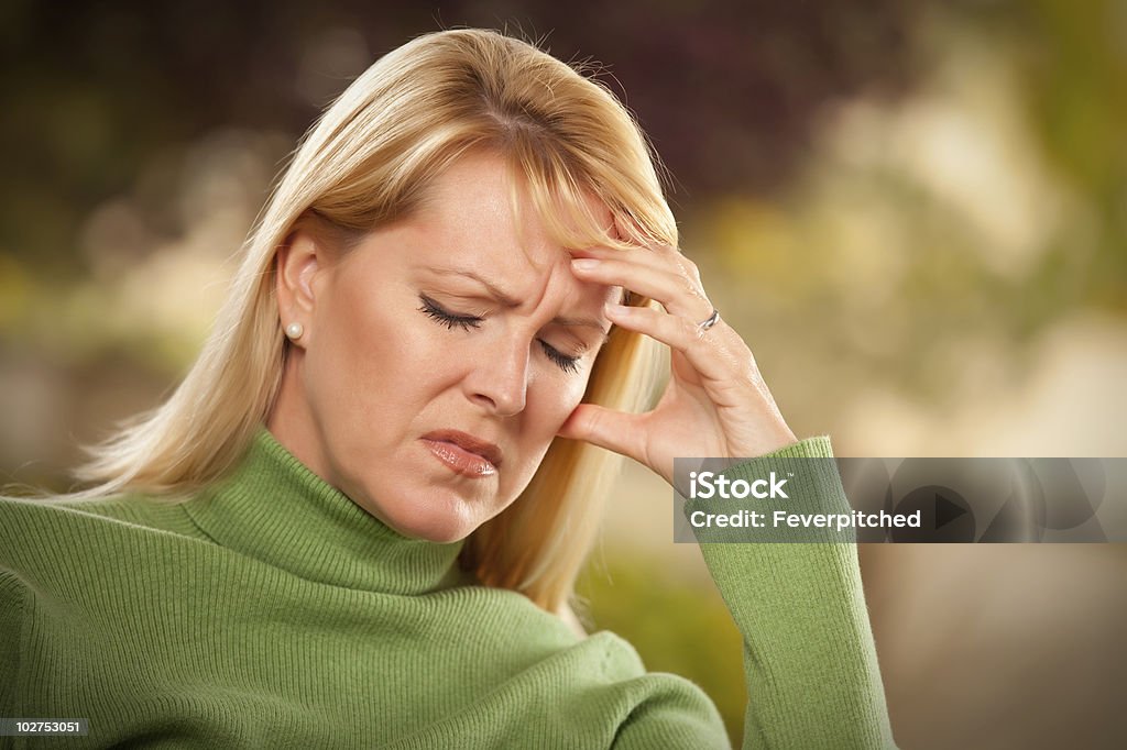 Grimacing Woman Suffering a Headache or Sorrow  30-39 Years Stock Photo