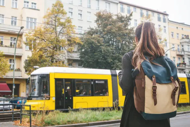 Photo of Girl tourist with a backpack on Berlin street in Germany