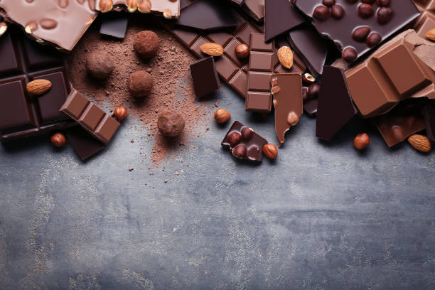 istock Chocolate pieces with nuts on grey wooden table 1027542820