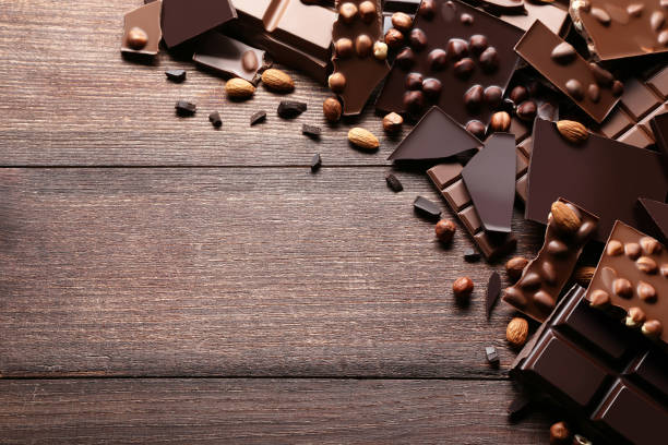 istock Chocolate pieces with nuts on brown wooden table 1027542946
