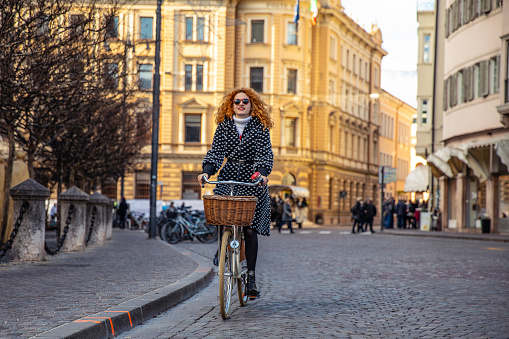 Woman cycling in Milan - Italy