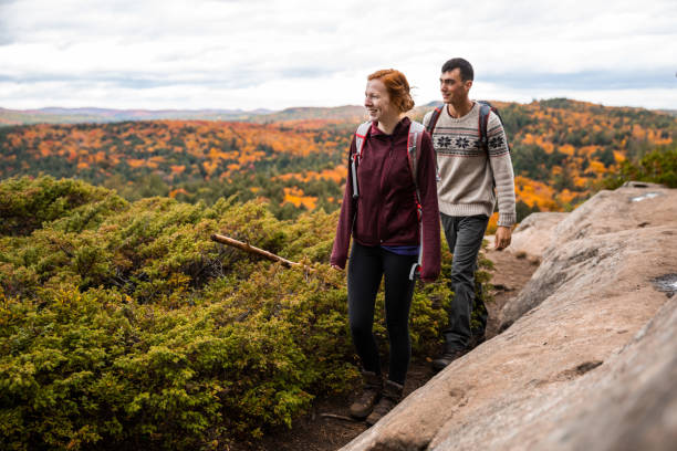 istock Young couple hiking in mountain on a footpath in Canada 1027543562