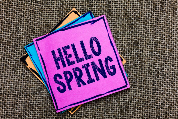 istock Handwriting text Hello Spring. Concept meaning Welcoming the season after the winter Blossoming of flowers Paper notes Important reminders Communicate ideas messages Jute background 1027543782