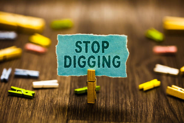istock Word writing text Stop Digging. Business concept for Prevent Illegal excavation quarry Environment Conservation Clothespin holding blue paper note reminder clothespins wooden floor 1027546010