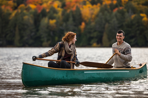 Young couple paddling in the wonder of nature in Canada
