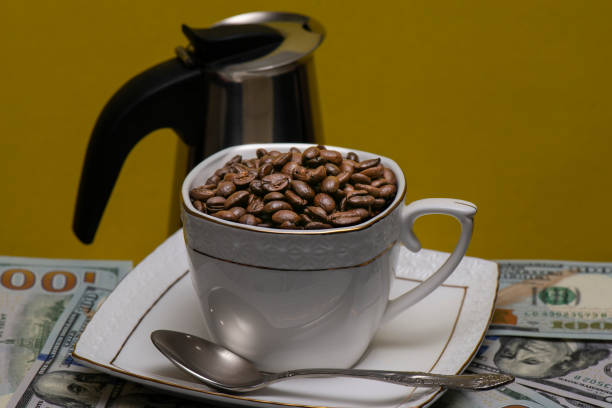 istock Cup of coffee beans on a Golden background 1027546776