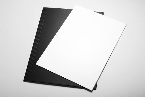 istock Blank sheets of paper over black folder 1027549720