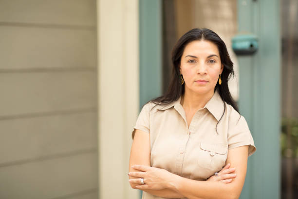 istock Happy Hispnaic woman smiling and standing outside. 1027552528