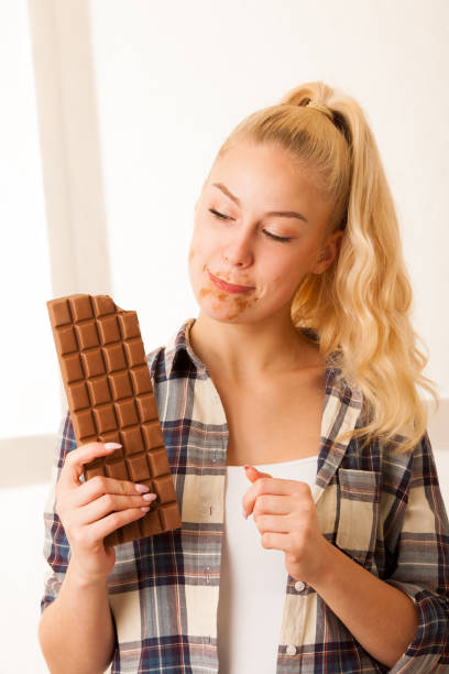 istock Beautiful blonde woman eats a big chocolate 1027554754