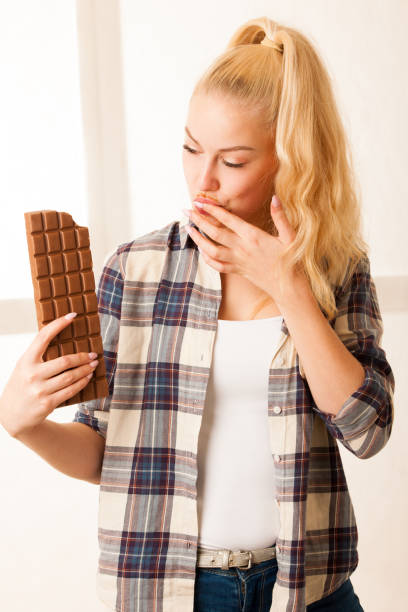 istock Beautiful blonde woman eats a big chocolate 1027554760