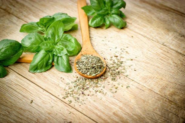 istock Basil - dry, dried and fresh basil in spoon on table 1027555512