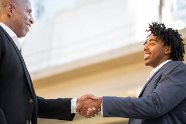 istock Mature African American casually dressed businessman shaking hands. 1027557326