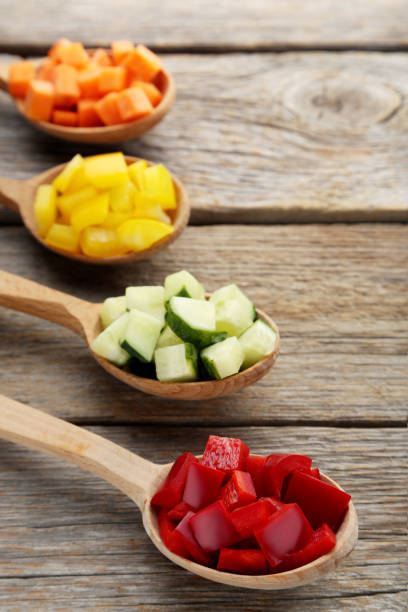 istock Fresh sliced vegetables in spoons on wooden table 1027558124