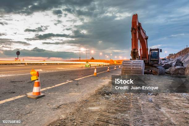 Works Of Extension Of A Road With Excavator And Delimited By Safety Cones Stock Photo - Download Image Now