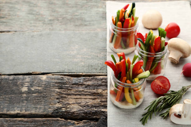 istock Sliced vegetables in glasses on wooden table 1027560334