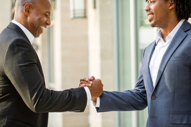 istock Mature African American casually dressed businessman shaking hands. 1027560700