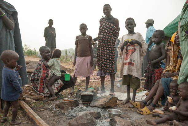Refugees prepare coffee for breakfast in displaced persons camp in Juba, South Sudan. stock photo