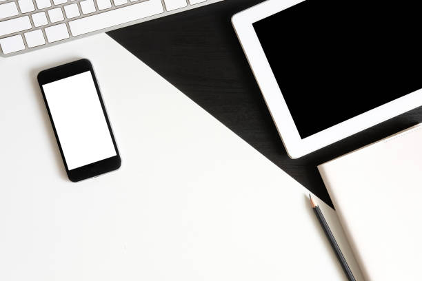 istock Mockup smartphone on table with tablet and notebook with pen A top view office desk, A monotone object concept. 1027564854