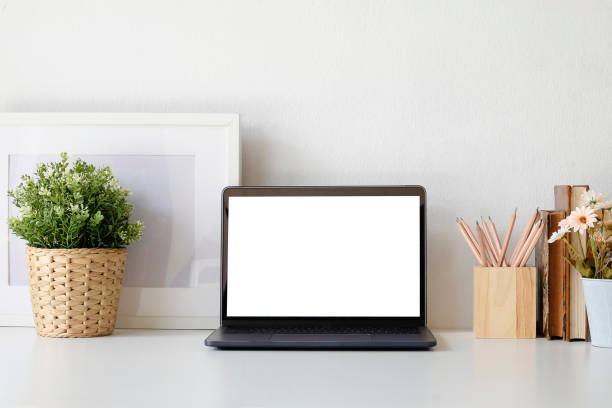 istock Workspace office desk with laptop computer plant and pencil pot on white table, Mock up laptop empty screen. 1027567764