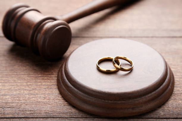 istock Judge gavel with wedding rings on wooden table 1027574784